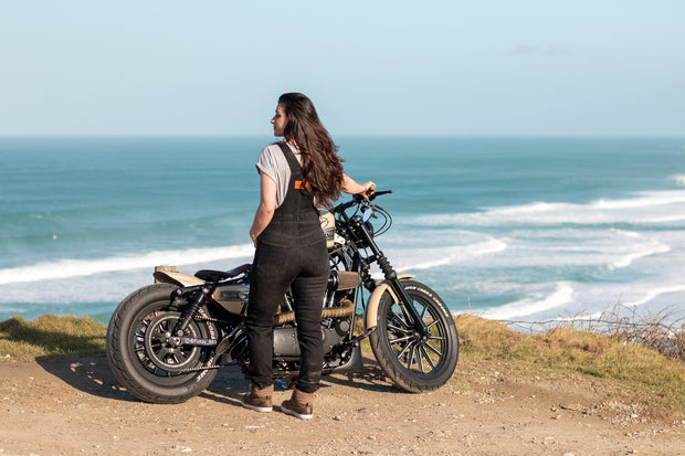 women-wearing-black-demin-dungarees-with-kevlar-beside-motorcycle