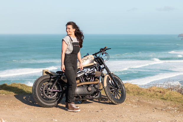 women-wearing-black-denim-overalls-standing-next-to-motorcycle