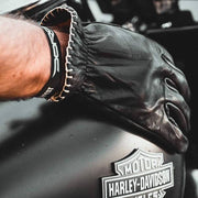 black-leather-motorcycle-gloves-on-harley-tank
